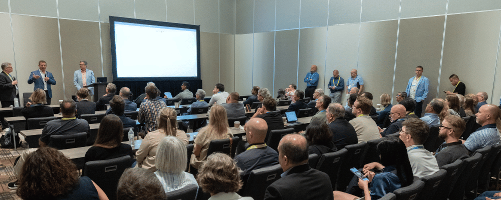 group of attendees watching a conference session