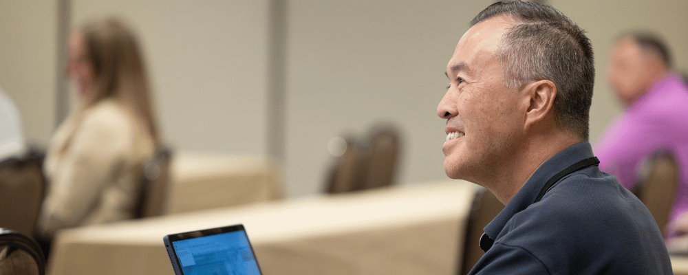 conference attendee watching a session