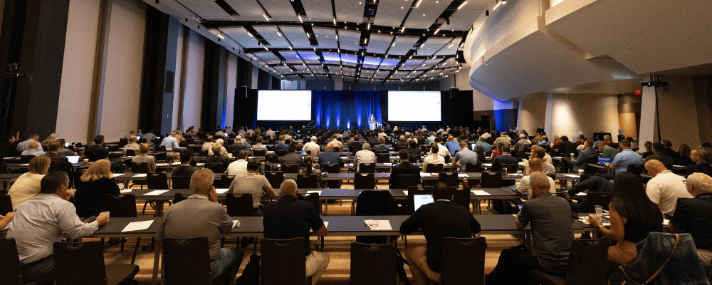 group of event attendees watching conference presentation