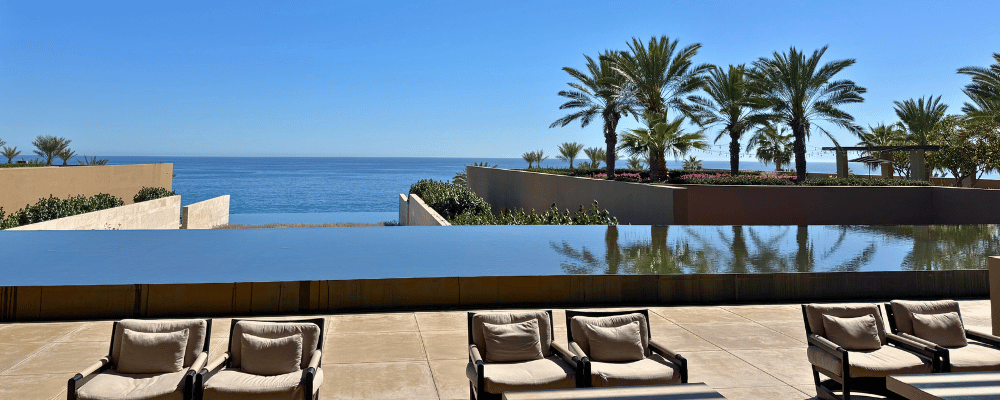 chairs and pool overlooking ocean at a venue in cabo