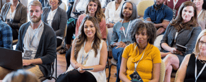 group of people watching a presentation at a conference