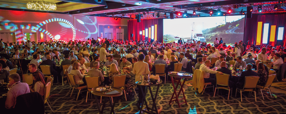 group of attendees watching a corporate conference presentation