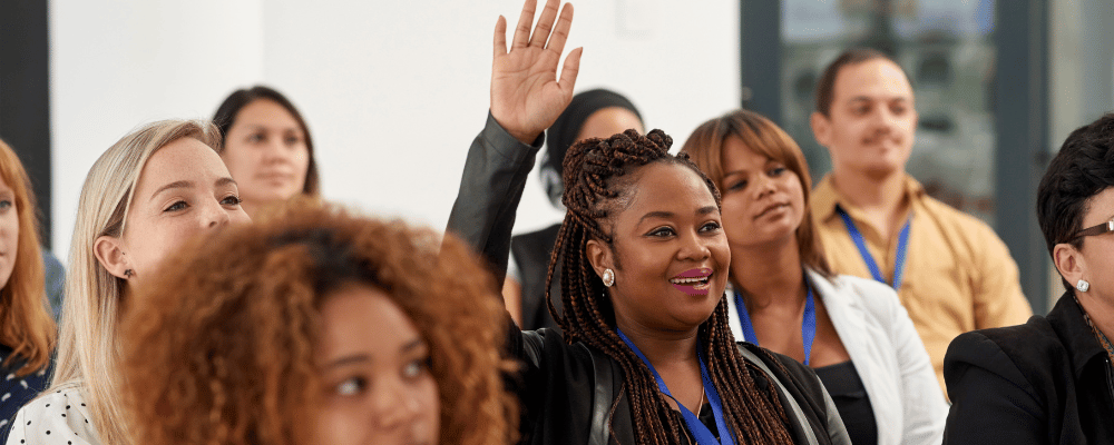 woman asking questions during a corporate conference event