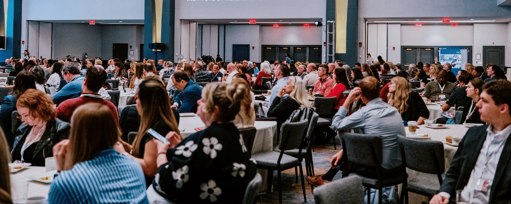 group of attendees watching a presentation at a corporate event venue