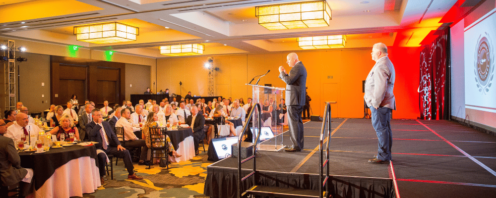 group of CEOs giving a presentation at a corporate conference