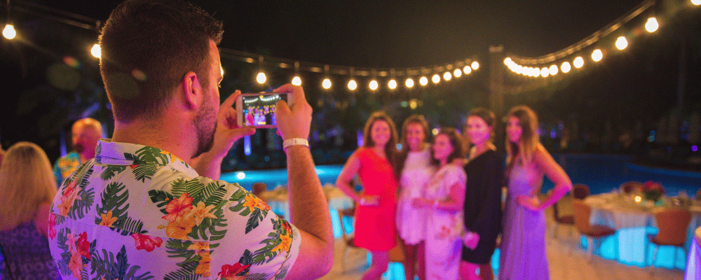man taking a photo of three woman at a corporate event