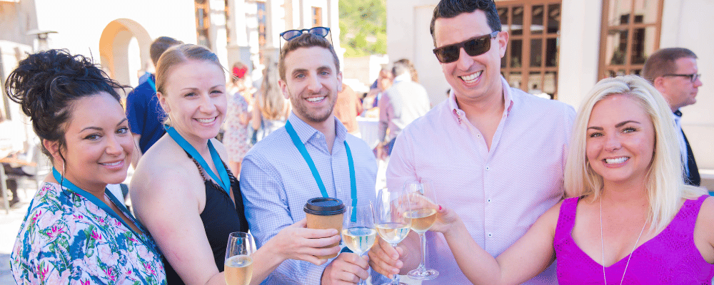 group of event attendees drinking wine