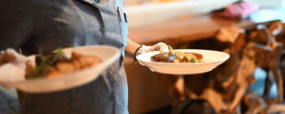 venue staff serving corporate event dinner