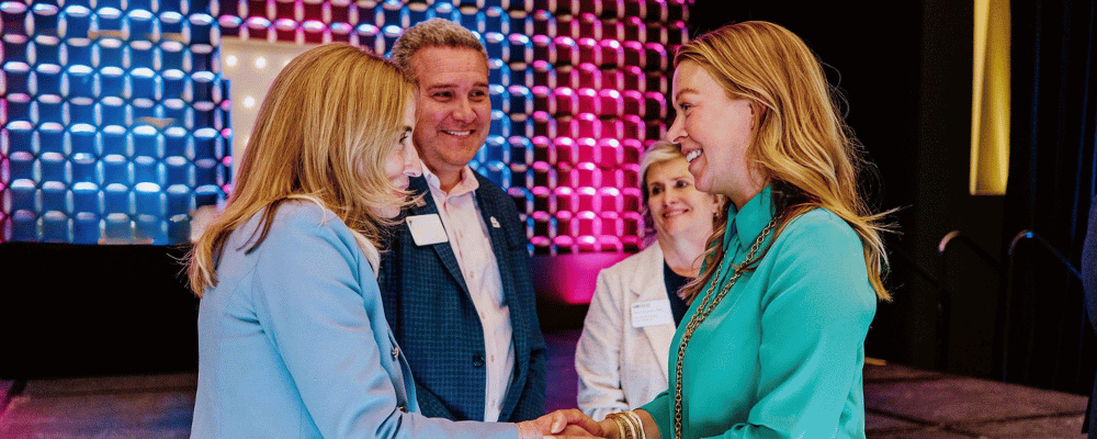event planning team talking during a corporate meeting