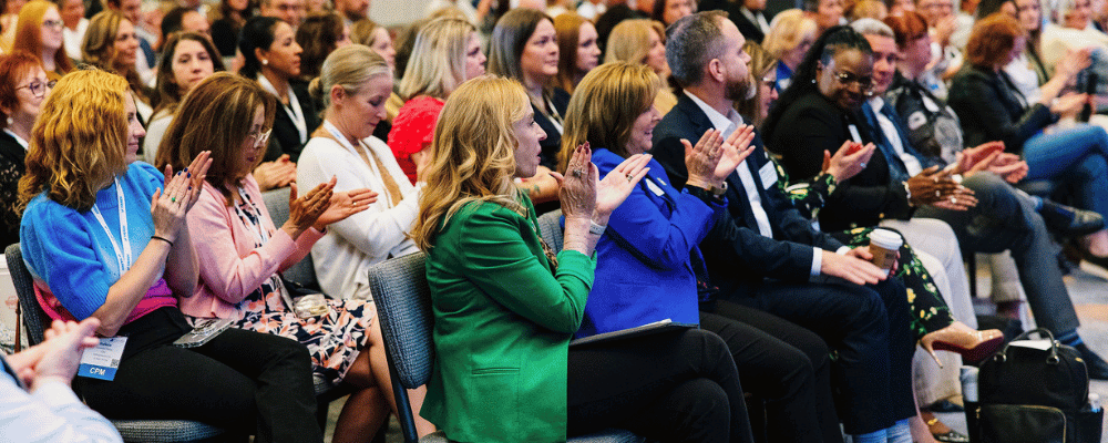 group of attendees clapping during a corporate event