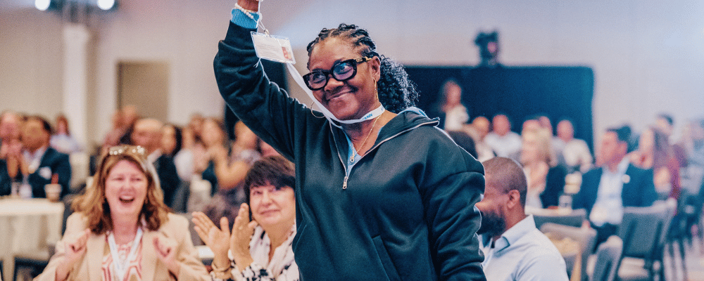 attendee celebrating while walking upstage during a corporate event