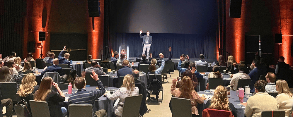 group of event attendees watching a conference presentation