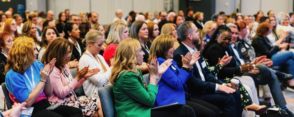 group of attendees watching a conference