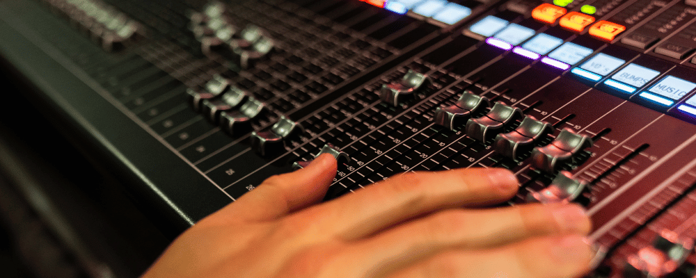 A/V producer adjusting the volumes of a corporate event