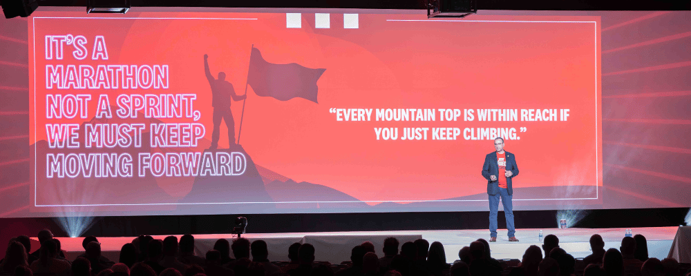 CEO giving a presentation at a corporate conference event