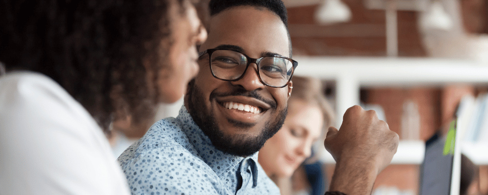 man smiling at woman at work event