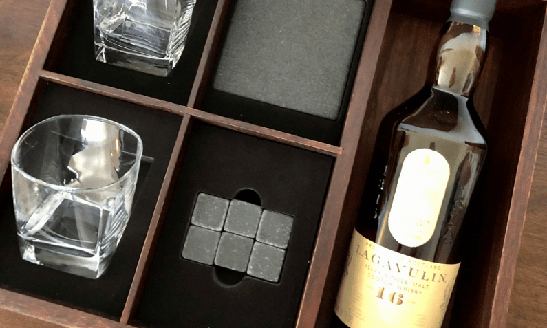 gift box featuring bottle of whiskey, high ball glasses, and whiskey stones