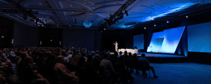 group of event attendees watching a conference