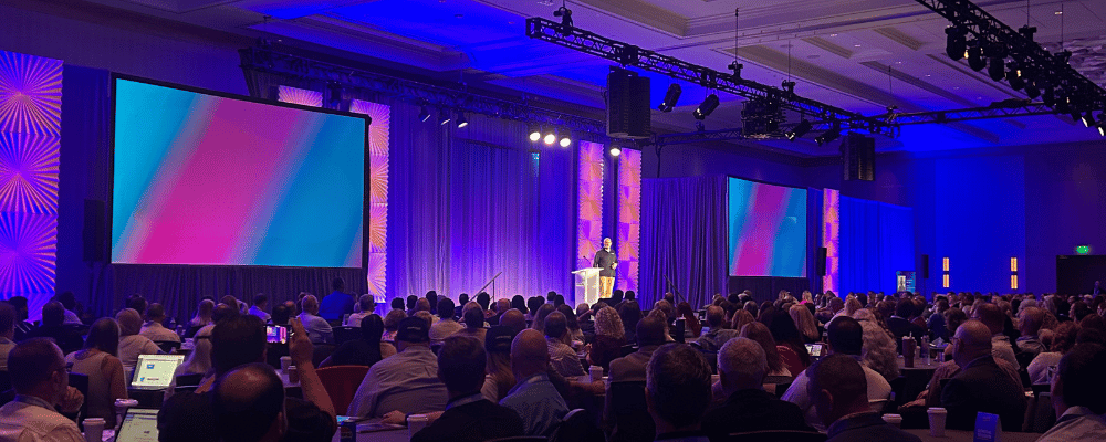 group of event attendees watching a conference presentation