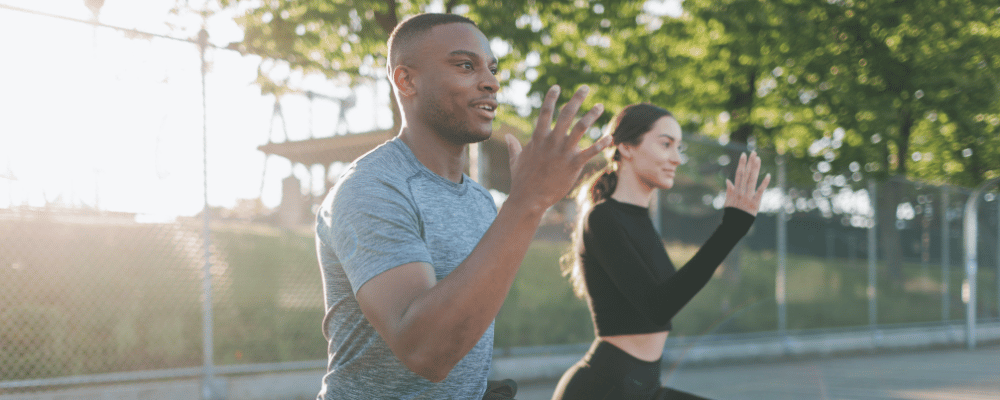 man and women exercising outside