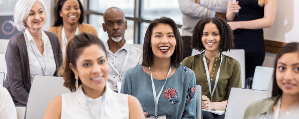 group of event attendees listening to conference presentation