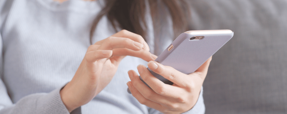 woman scrolling on her iphone during an event