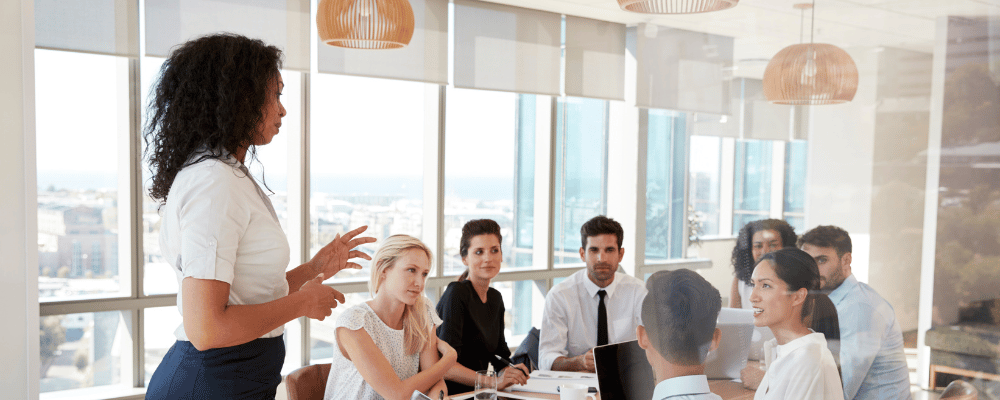 woman giving presentation to event attendees at a conference