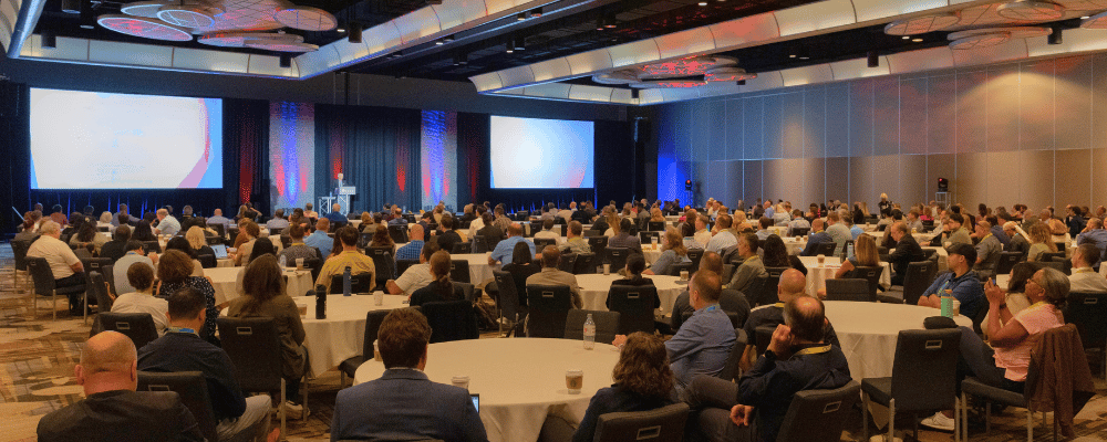 group of attendees watching a conference presentation