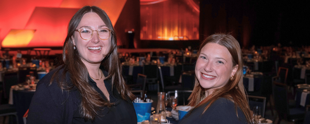 two event managers smiling at an awards dinner