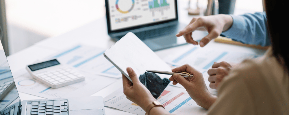 woman measuring event analytics on tablet and laptops