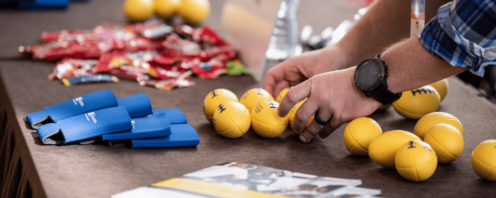 woman organizing event giveaway items on a table