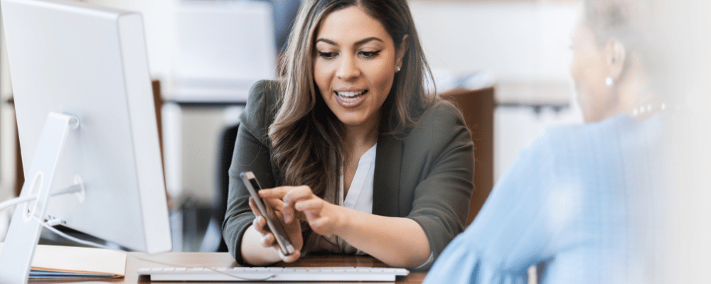 Woman using paid event management app with coworker on phone