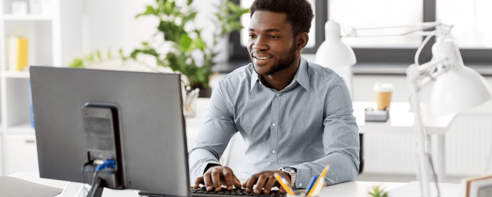 Man at computer using free event management software