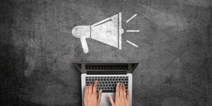megaphone and person on their computer searching event marketing strategies