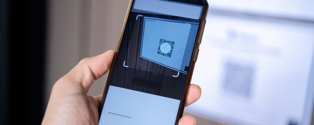 person scanning flyer QR code with cell phone