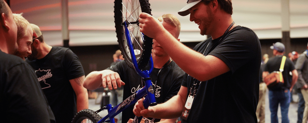 a group of people building a bike at an event