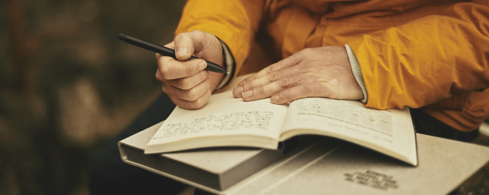 man journaling for wellbeing at an executive wellness retreat