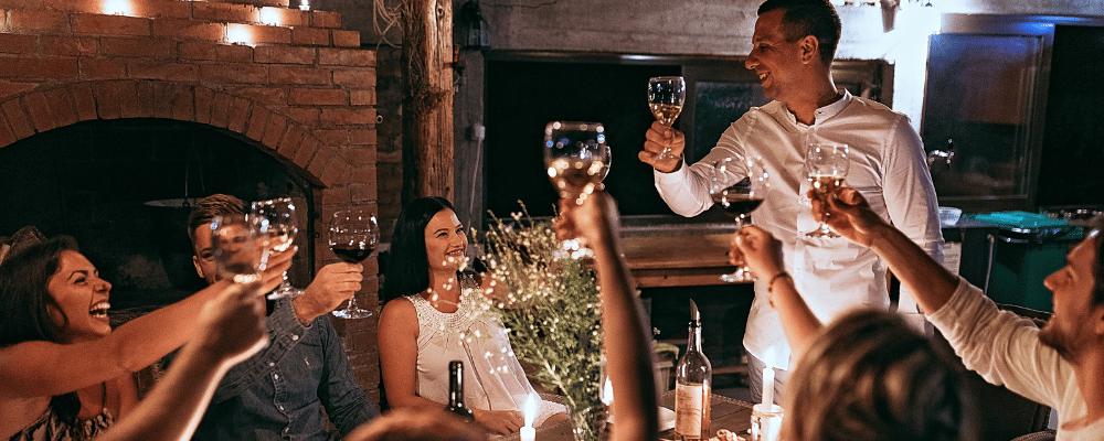 group of executives at wellness retreat enjoying glasses of wine together