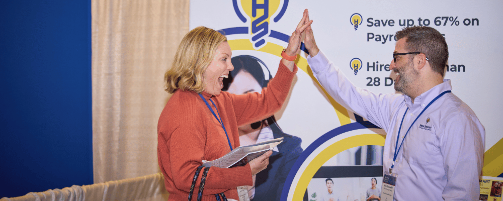 attendee giving an expo worker a high five at a tradeshow