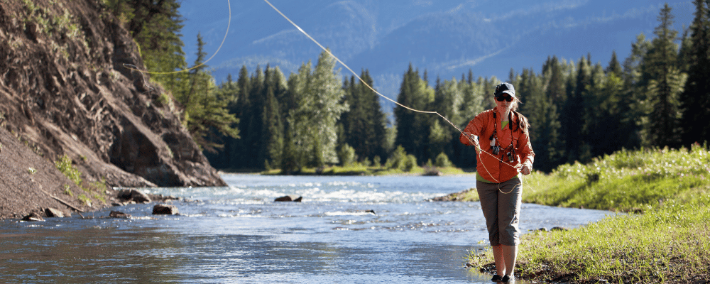 woman fly fishing in river