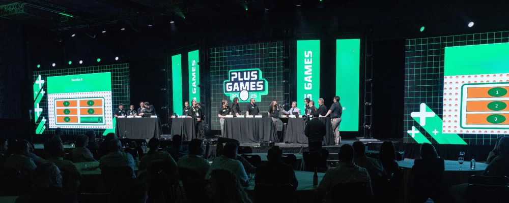 group of attendees participating in a game show on stage