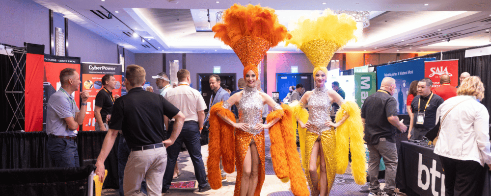 showgirls walking around a tradeshow in vegas