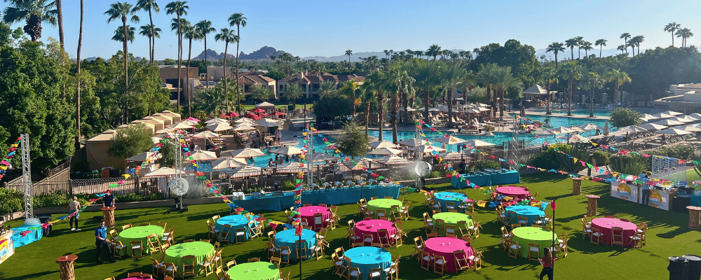 group of event attendees enjoying lunch by the pool