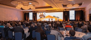 group of attendees watching a presentation at a conference