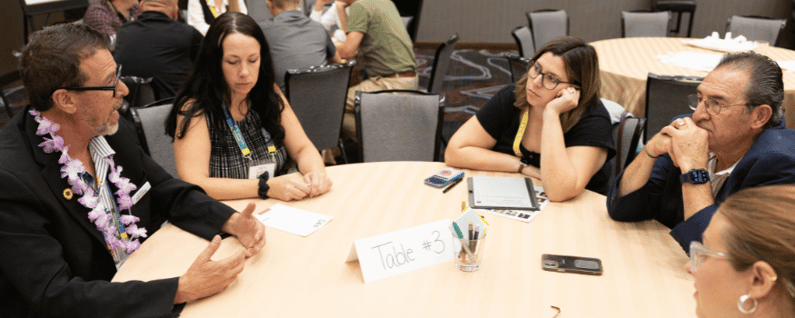 group of attendees at a round table breakout session