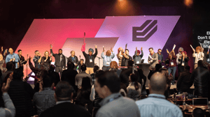 group of people on stage at a conference 