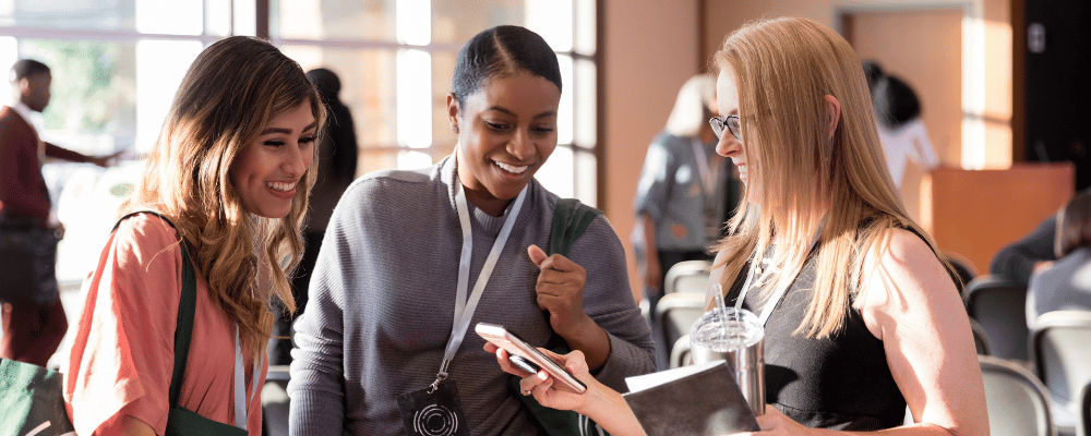 A group of women at an event using event technology