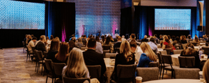 group of event attendees watching a corporate conference presentation