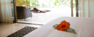 hotel room with flower on bed at incentive resort
