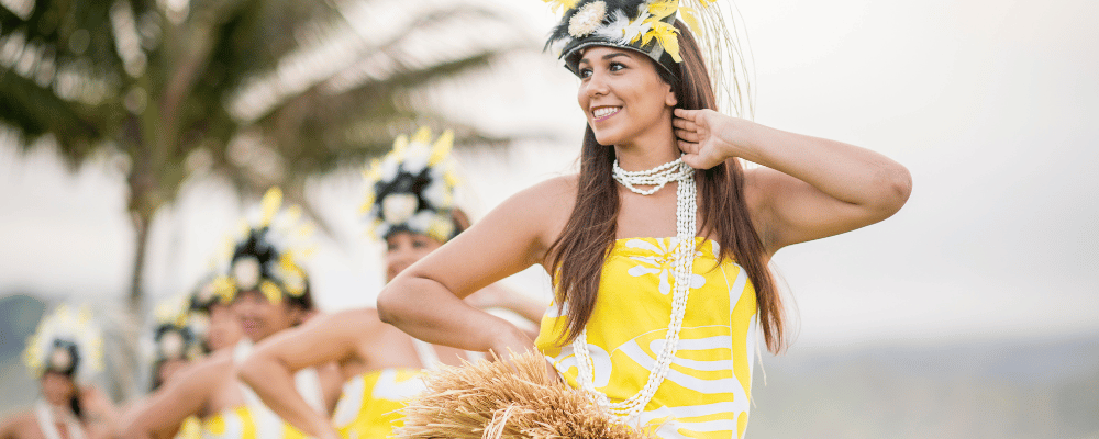 woman wearing a yellow dress hula dancing in Maui, Hawaii